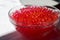 Glass bowl full of red jelly balls