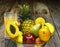 GLASS BOWL FULL OF VARIOUS FRUITS AND GLASS OF JUICE BEHIND