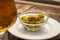 Glass bowl with green andalusian olives served on outdoor terrace in Andalusia, Spain