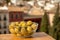 Glass bowl with green andalusian olives served on outdoor terrace with view on old part of Granada, Andalusia, Spain