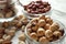 Glass bowl with hazelnuts on table, closeup