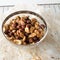 Glass bowl of mixed nuts on parchment paper and cooling rack