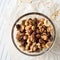 Glass bowl of mixed nuts on parchment paper and cooling rack