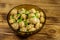 Glass bowl with pickled champignons. Marinated mushrooms on wooden table