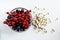 Glass bowl with ripe berries and various types of vitamin D