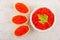 Glass bowl and tartlets with imitation red caviar on table