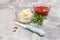 Glass bowls with ketchup and cheese sauce on kitchen table.