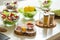 Glass bowls with salads and vegetables with spices on the foreground