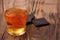 Glass of brandy, whisky, cognac on a wooden table-top with chocolate bars