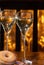 Glass of brut champagne bubbles wine in tulip glass and glazed, yeast-raised, American-style ring doughnut on evening bar lights