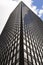 Glass building, skyscraper in midtown, in Manhattan with reflection and blue sky