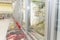 Glass cabinets with refrigerated food in the supermarket. Side view. Blurred