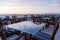 Glass cafe tables on the roof of the resort with views sea and beautiful sunset