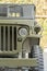 Glass car headlight and grille, cooling fan. Fragment of old army jeep vehicle, closeup. India