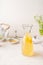 Glass carafe with white tea lemonade drink on white kitchen table