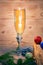 A glass of champagne.Bubbly. A goblet of Sparkling wine. A wineglass of Fizz. Christmas background. A candle champagne