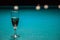 A glass of champagne is on the pool table. the winner of the game, the champion drinks a glass of sparkling wine. Hobbies, sports