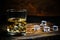 Glass chilled whiskey with ice cubes on wooden background in cellar