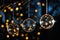 Glass christmas decorations hanging from a christmas at night. Bokeh background. Night time, stars, christmas lights. AI
