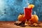 Glass of christmas hot mulled wine on wooden table with species and oranges against frozen window.Copy space