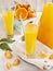 Glass of Citrus juice and oranges and mandarines