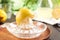 Glass citrus squeezer with lemon half on plate