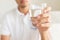 A glass of clean mineral water in man`s hands.