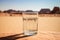 Glass of clean water in desert sand drought climate change global warming concept
