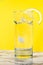 A glass of clear clear water with lemon. Juicy lemon