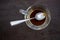 Glass coffee cup, finished americano coffee drink left over and siver spoon on wooden table background, Close up shot