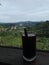 A glass of coffee and a natural view of the Sianok Gorge in West Sumatra