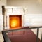 Glass coffee table top with a blurred fireplace and home interior background. Empty space for your products and decoration.