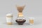 Glass coffeemaker with paper filter and disposable coffee cups. Transparent carafe with brewed espresso and cardboard