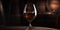 Glass of cognac on the table in the cellar of traditional winery