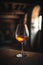 Glass of cognac on the table in the cellar of traditional winery