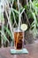 Glass of coke drink with ice and lime on a nature background on a wooden table. Bali island.