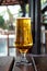 A glass of cold beer amber color with condensation on a wooden table in a pub  bar. Alcohol drink. Summer leisure concept