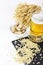 Glass of cold beer with chips and peanuts on white background