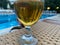 Glass Of Cold Beer On Pool Board In Hot Summer Day