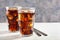 Glass of cold cola soft drink with ice on wooden background