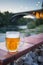 Glass of cold draught lager beer standing on a table outdoors next to the Moraca river,Podgorica,Montenegro