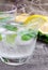 Glass of cold sparkling water with lemon and mint