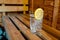 glass of cold water with lemon on sauna bench