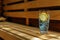 glass of cold water with lemon on sauna bench