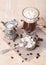 Glass Cup of coffee with marshmallow, milk jug and coffee beans