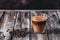 Glass cup of coffee with milk. Hot latte or cappuccino coffee. Wooden dark table. Selective focus