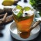 Glass cup of ginger tea with lemons and mint leaves on dark background. Square image, cold and autumn time