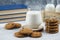 A glass cup of tasty milk with cookies and books