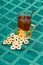 Glass cup of tea in an aluminum cup holder with fragrant green bagels on tablecloth