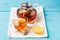 Glass cup of tea with lemon, glass teapot and honey.